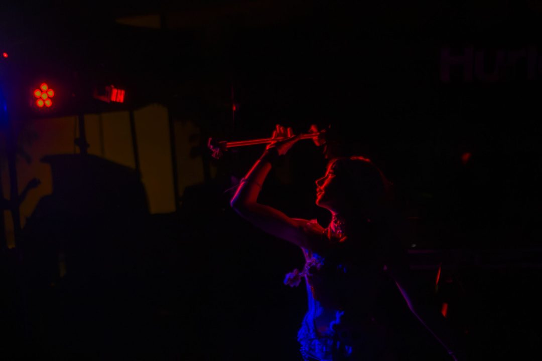 girl playing with flowersticks in dimmed party light