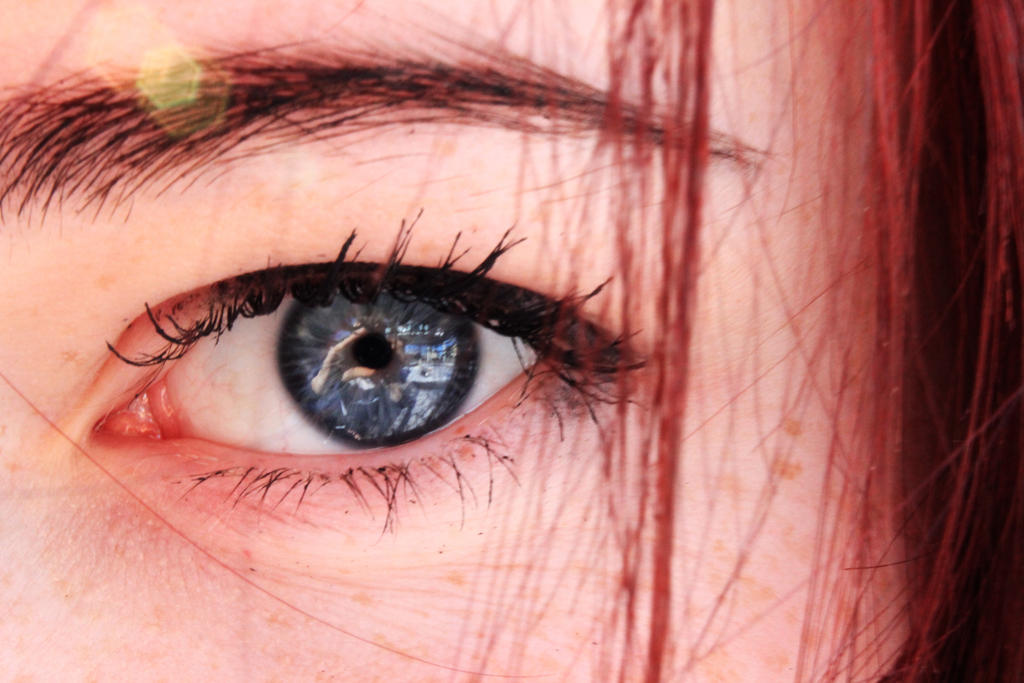 Closeup photo of girl with red hair focussed on the pupil of the eye